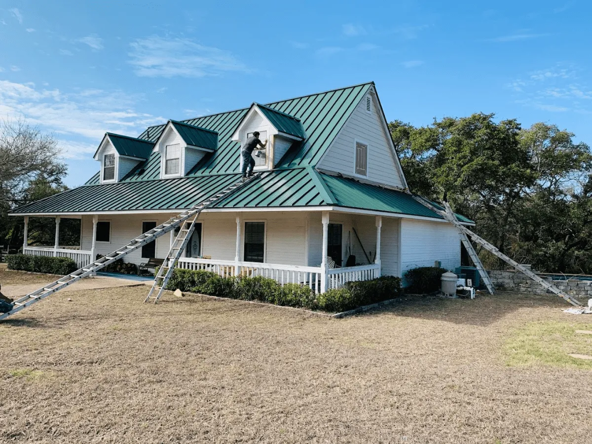 Ark worker installing a new metal roof on an Austin home