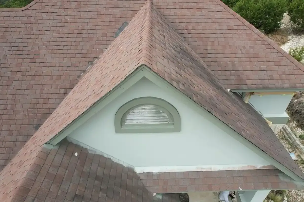 Brown shingle roof with a dormer vent on an Austin home