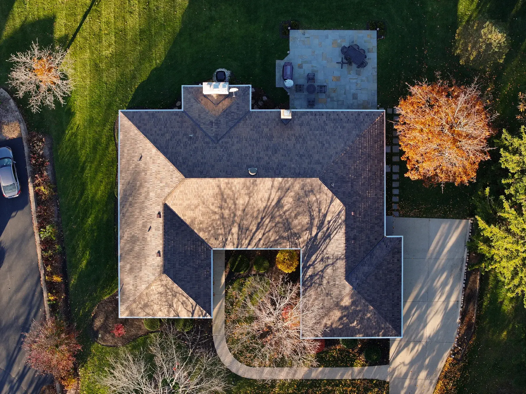 Synthetic cedar shake roof installation on a residential home