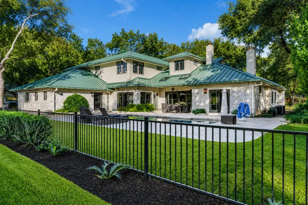 Stone home with a green standing-seam metal roof