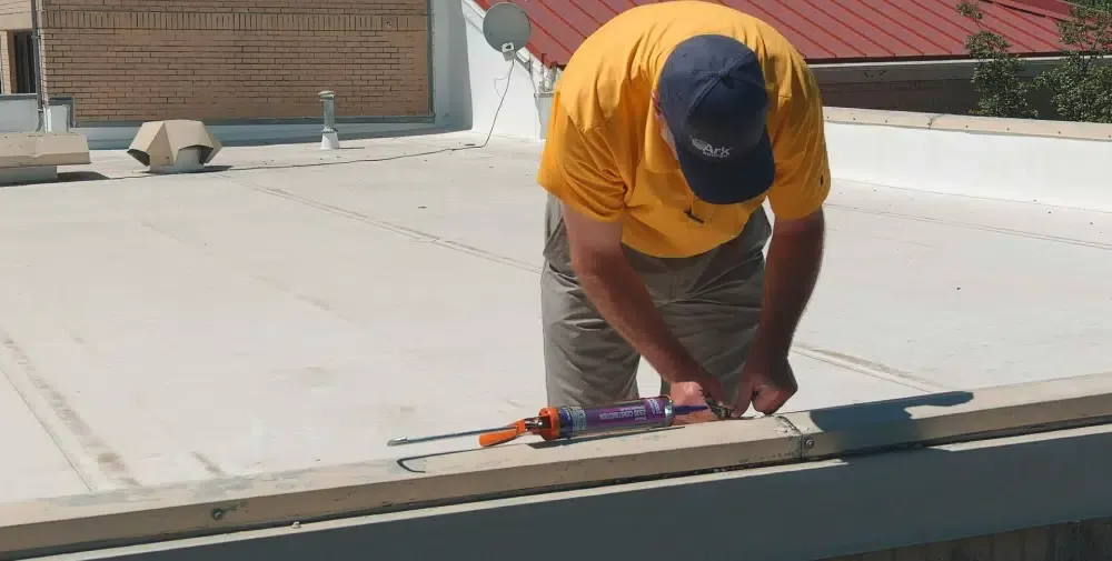 Ark technician servicing a commercial roof in Austin