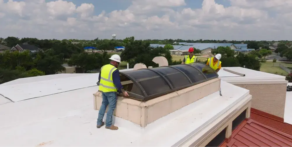 Ark crew installing a skylight on a commercial roof