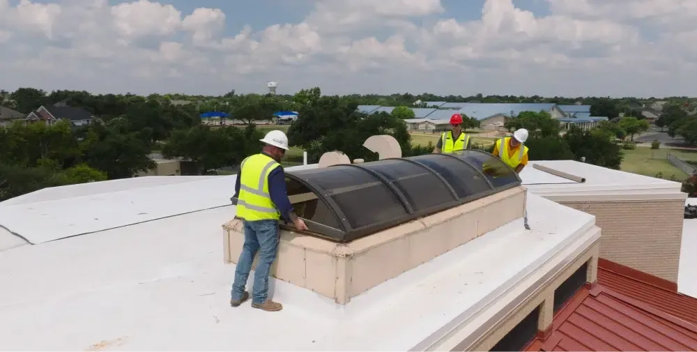 Ark crew installing a skylight on an Austin commercial roof