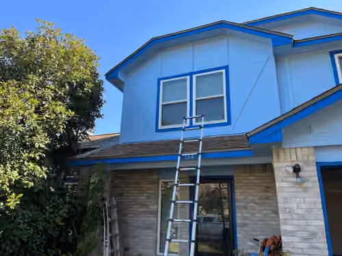 Blue siding and white trim on a home exterior