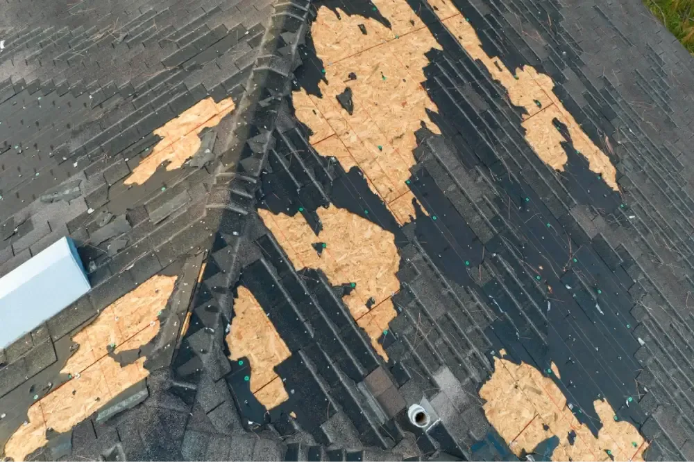 Old asphalt shingles stripped down to the roof decking on an Austin home